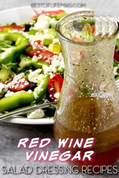 salad dressing recipe with red wine vinegar in a glass bottle next to a plate of salad