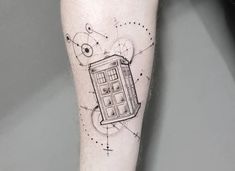 a tattoo on the leg of a person with a doctor who is holding a phone