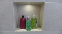 three different types of soaps and lotions in a niche