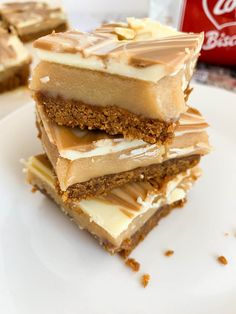 three pieces of dessert sitting on top of a white plate next to a can of coke