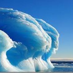 an iceberg in the ocean with blue water