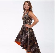 a woman in a camo print dress posing for a photo with her hands on her hips