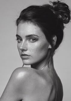 a black and white photo of a woman with freckled hair