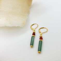 In ancient Egypt, gold was believed to reflect the life-giving rays of the sun. The color and brilliance of gem stones traditionally determined their value and religious significance. These earrings feature aventurine, making them perfect for those who appreciate the beauty of natural gems. The tranquil green shade and intricate veining adds a unique touch to any jewelry collection. Materials: aventurine tube, carnelian, pewter with gold finish Length: 1 1/2" Made in USA Elegant Aventurine Dangle Earrings, Gold Aventurine Earrings Gift, Aventurine Natural Stone Earrings, Aventurine Natural Stone Earrings Gift, Carnelian Gold Earrings With Ear Wire, Gold Carnelian Earrings With Ear Wire, Gold Jade Gemstone Earrings, Gold Bohemian Carnelian Earrings, Bohemian Gold Carnelian Earrings