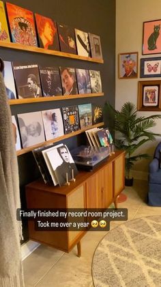 a living room filled with furniture and lots of pictures on the wall next to a blue chair