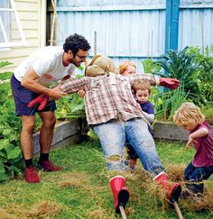 a man and children are in the garden