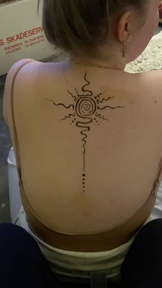 a woman with a tattoo on her back