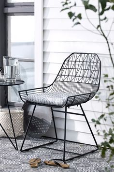 a chair sitting on top of a tiled floor next to a table