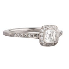 an engagement ring with a square cut diamond in the center and pave set shoulders