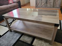 a coffee table sitting on top of a rug in a living room