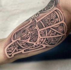 a man's arm with an intricate tattoo design on it