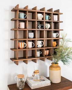 a wooden shelf with coffee mugs on it