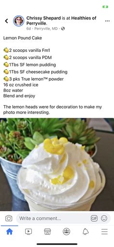 a cup with whipped cream and lemon on top, next to a potted plant