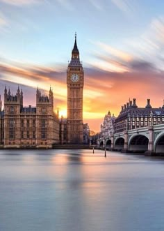 the big ben clock tower towering over the city of london, england at sunset or dawn