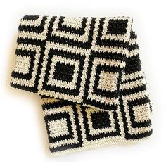 two black and white crocheted squares sitting on top of each other