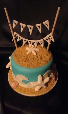 a blue and white birthday cake on a black background