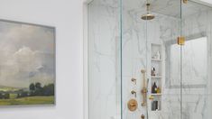 a bathroom with marble walls and flooring next to a walk - in shower area