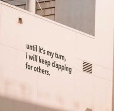 a sign on the side of a building that says until it's my turn, i will keep clapping for others