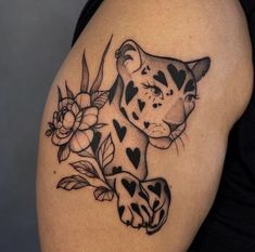 a black and white tattoo of a tiger with hearts on it's back shoulder