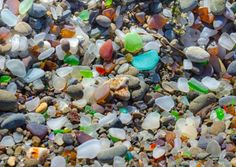 many different colored glass pebbles on the ground