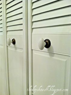 two white cupboards with knobs on them