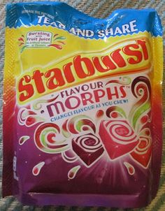 a bag of stardosh flavored candy sitting on top of a carpet covered floor