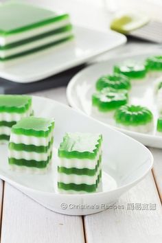 pieces of green jello sitting on top of white plates