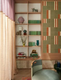 a living room filled with furniture and bookshelves next to a curtained window