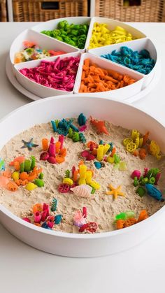 two bowls filled with different colored toys on top of a white table next to each other