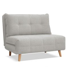 a gray couch sitting on top of a white floor next to a wooden leg chair