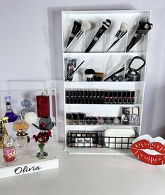 a display case filled with lots of cosmetics and other beauty products on top of a white table