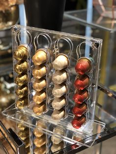 several different types of beads on display in a clear case with acrylic handles