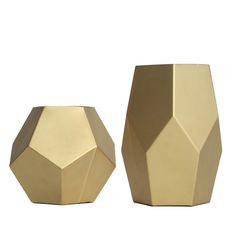 two gold vases sitting next to each other on a white surface, one is shaped like an octagon