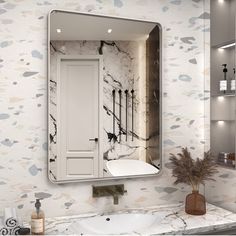 a bathroom with marble walls and flooring is shown in the mirror above the sink