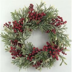 a wreath with red berries and green leaves