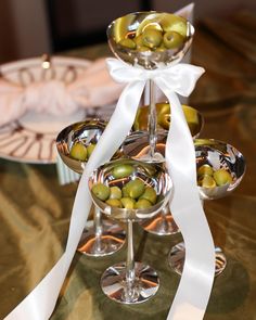 olives in martini glasses with white ribbon on table