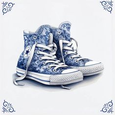 a pair of blue and white shoes on top of each other in front of an ornate frame