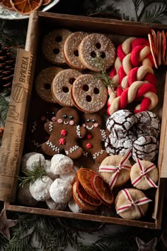 a box filled with lots of different types of cookies and pastries on top of a table