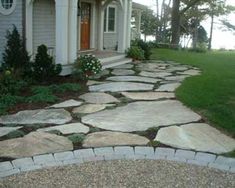 a stone walkway in front of a house