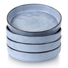 four blue dishes stacked on top of each other