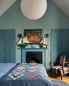 a bed room with a neatly made bed next to a fire place and a painting on the wall