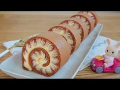 there is a cake that looks like a spirally pastry on a plate with a toy car next to it