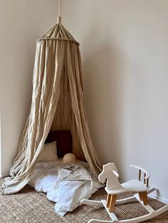 a child's bedroom with a bed and rocking chair in the corner next to it