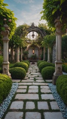 a garden with stone walkways and green plants on either side, surrounded by greenery