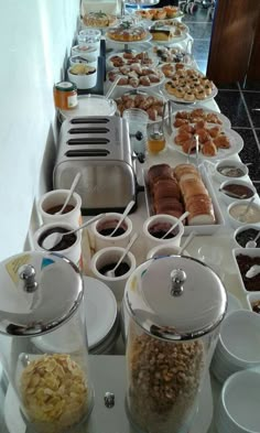 a buffet table filled with lots of food and desserts on it's sides