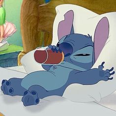 a cartoon character laying in bed drinking from a bottle