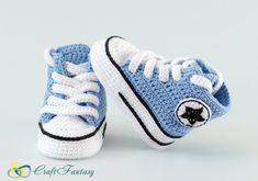 a crocheted blue and white baby's sneaker with a black star on the side