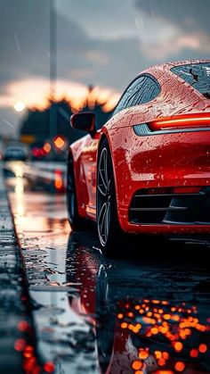 a red sports car is parked in the rain