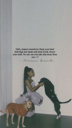 a girl in a white dress petting a cat and dog with a quote on the wall behind her