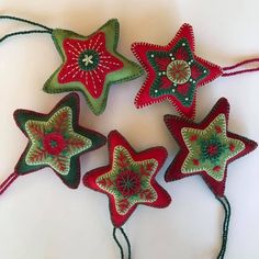 four red and green stars hanging from string